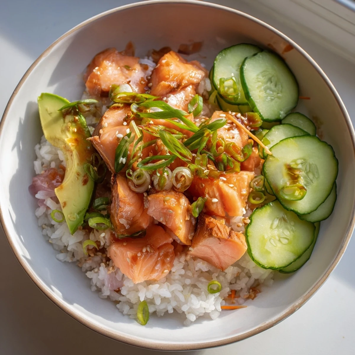 This Japanese-Style Salmon & Chicken Rice Bowl features flaky salmon next to tender chicken, ready to be enjoyed.