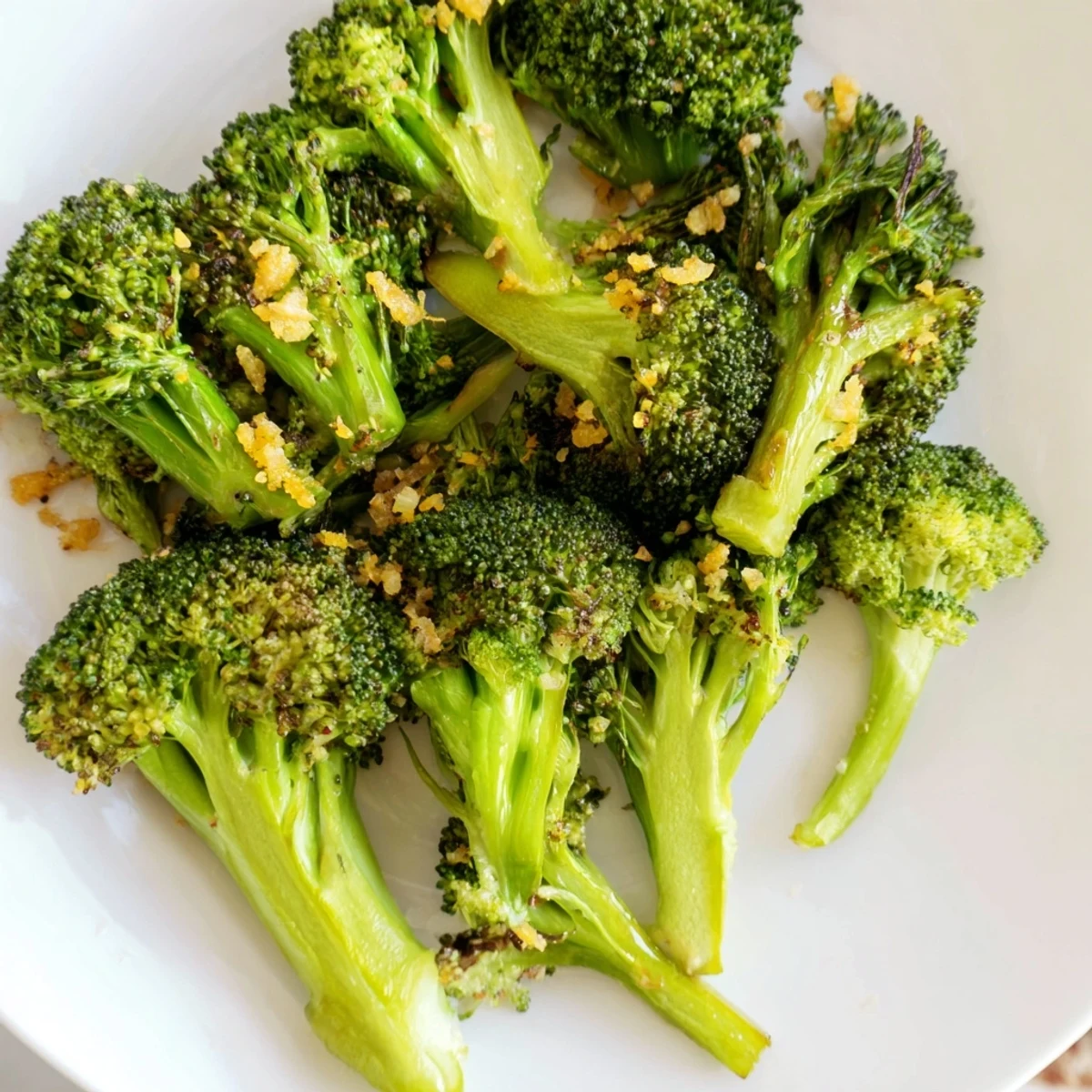 Crispy, golden Lemon Garlic Roasted Broccoli glistens, tossed in lemon juice and ready for dinner.