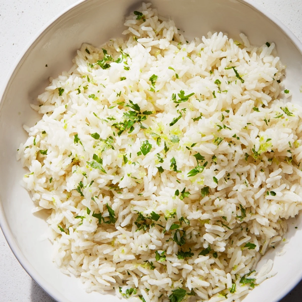A close-up of fragrant cilantro lime rice, with visible flecks of cilantro and zest, ready to serve.