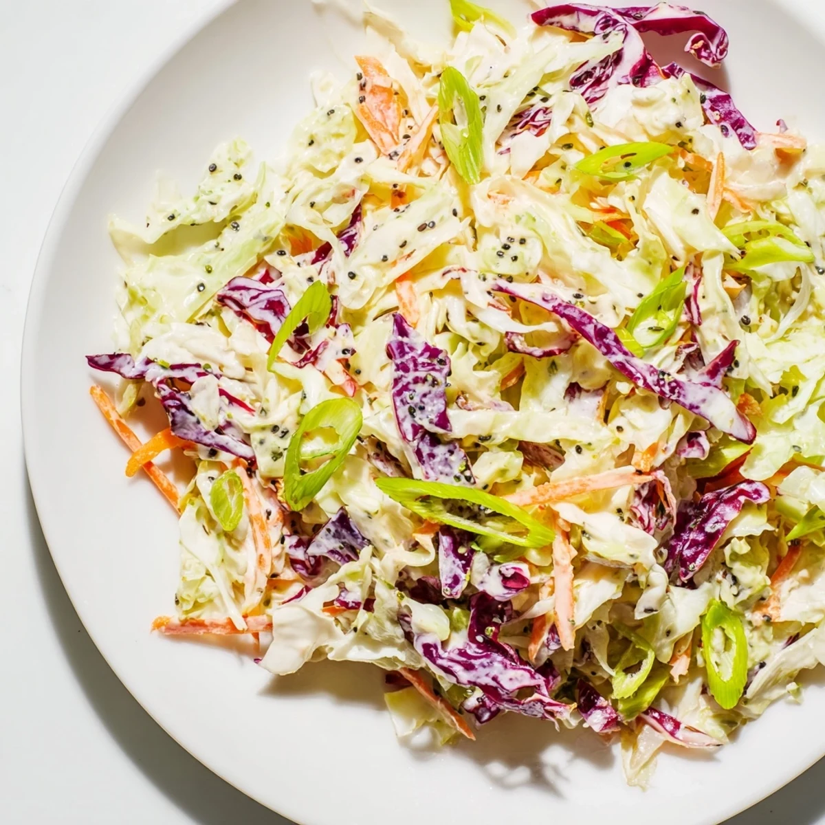 Freshly made quick coleslaw salad, showing shredded cabbage and carrots, perfect for summer barbecues.