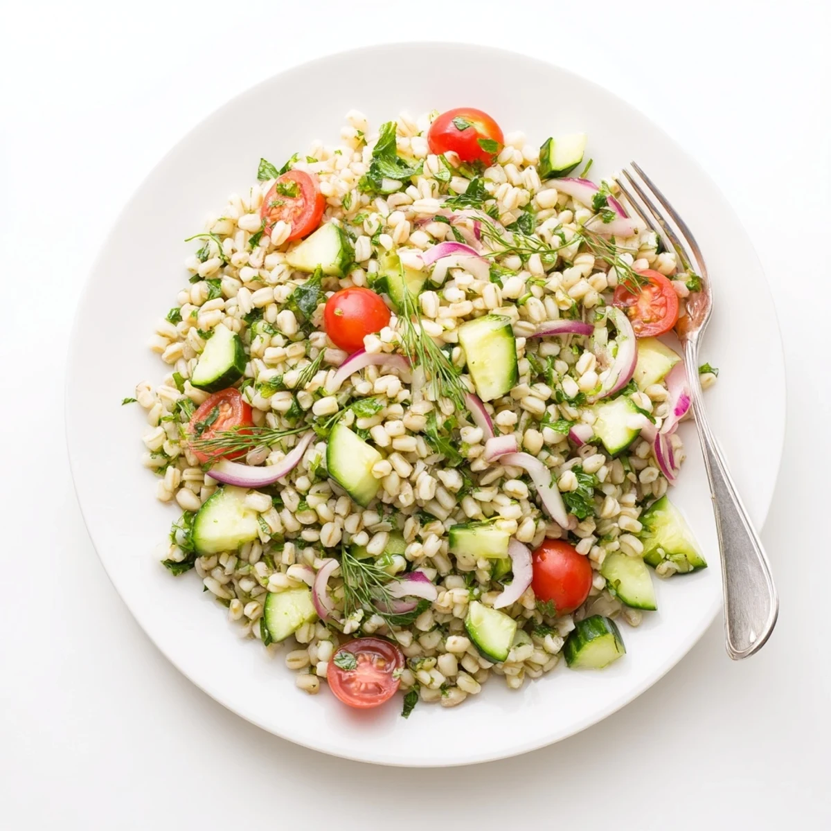 Fluffy Barley and Herb Salad served in a rustic bowl, garnished with fresh herbs and lemon zest, perfect as a light vegetarian lunch.