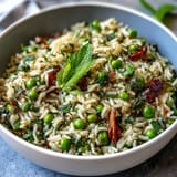 Colorful Spring Pea and Mint Rice Pilaf, a bright vegetarian side with tender peas, fresh mint, and zesty lemon notes.  