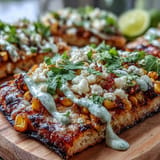 Festive Cinco de Mayo street corn flatbread, ready for drizzling with lime wedge.
