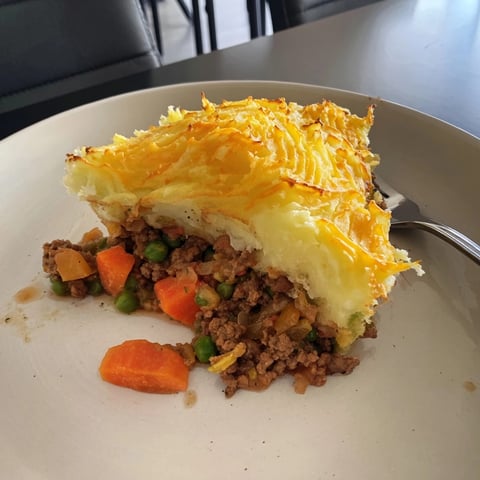 Close-up of golden, bubbling Warm Rustic Shepherds Pie with Cheesy Potato Topping, ready to serve.