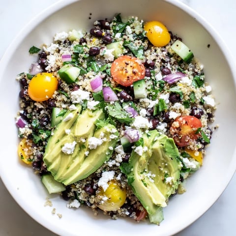 Vibrant Poppy-Bright Colorful Quinoa and Black Bean Salad, full of fresh vegetables, chilled and ready.