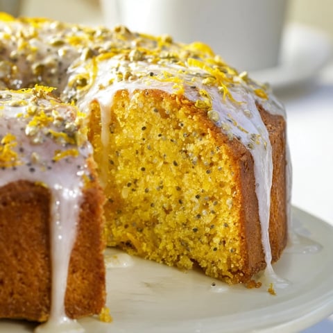 Moist Glazed Lemon Poppy Seed Cake, freshly baked and drizzled with a rich, tangy lemon glaze.