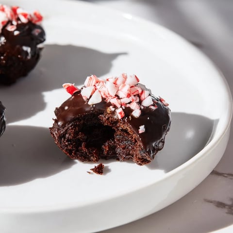 Fudgy Peppermint Mocha Brownie Bites are topped with a glossy glaze and crushed peppermint for a treat.