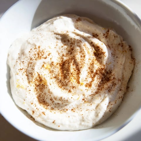 Creamy Greek Yogurt Fruit Dip, drizzled with honey, ready to serve with colorful fruit slices.