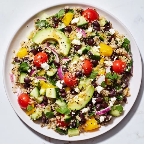 A refreshing bowl of Poppy-Bright Colorful Quinoa and Black Bean Salad; notice the bright colors and textures.