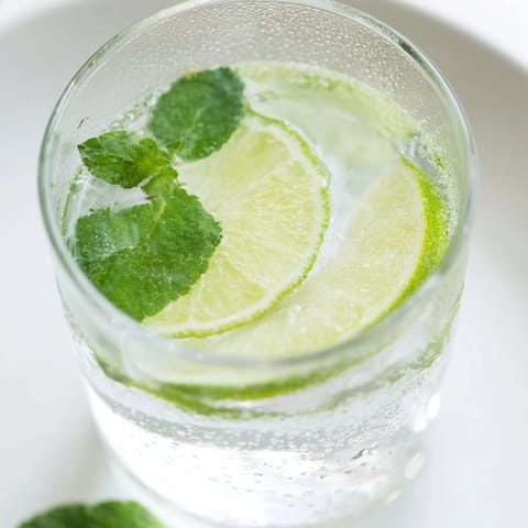 Ice-filled pitcher of vibrant Mint Lime Agua Fresca, perfect for quenching summer thirst.