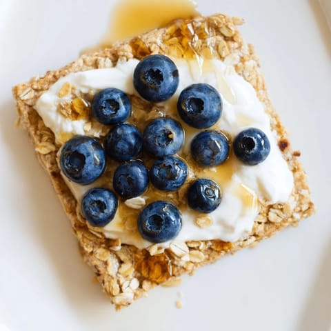 A close-up of warm, delicious Protein Pancake Oats served with fresh fruit on top.