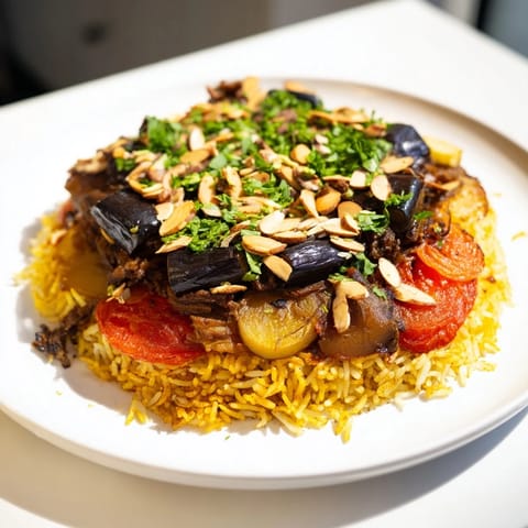 Golden roasted vegetables and tender lamb combine in this flavorful Palestinian Maqluba recipe.