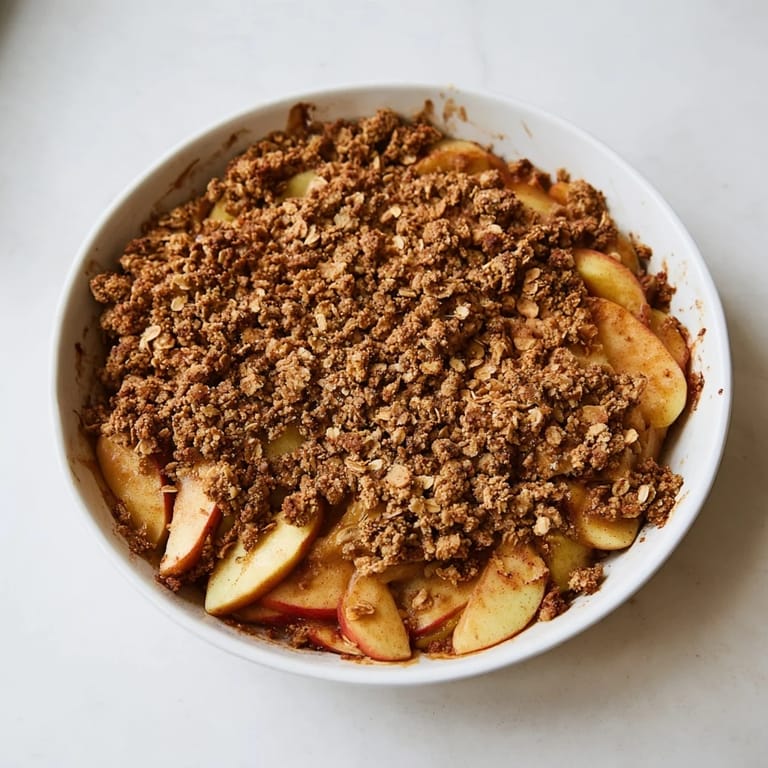 Warm Soft Crumb Comfort Dessert: Spiced Apple Crisp bubbling in a baking dish, ready to serve and enjoy.