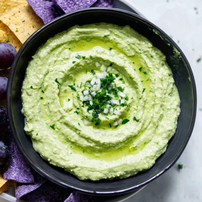 Spooky appetizer: The Witch's Brew Cauldron dip surrounded by black olives, grapes, and red onion slices.