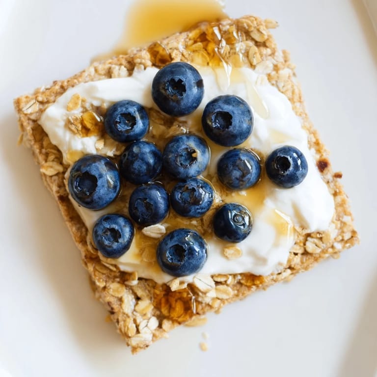 A close-up of warm, delicious Protein Pancake Oats served with fresh fruit on top.